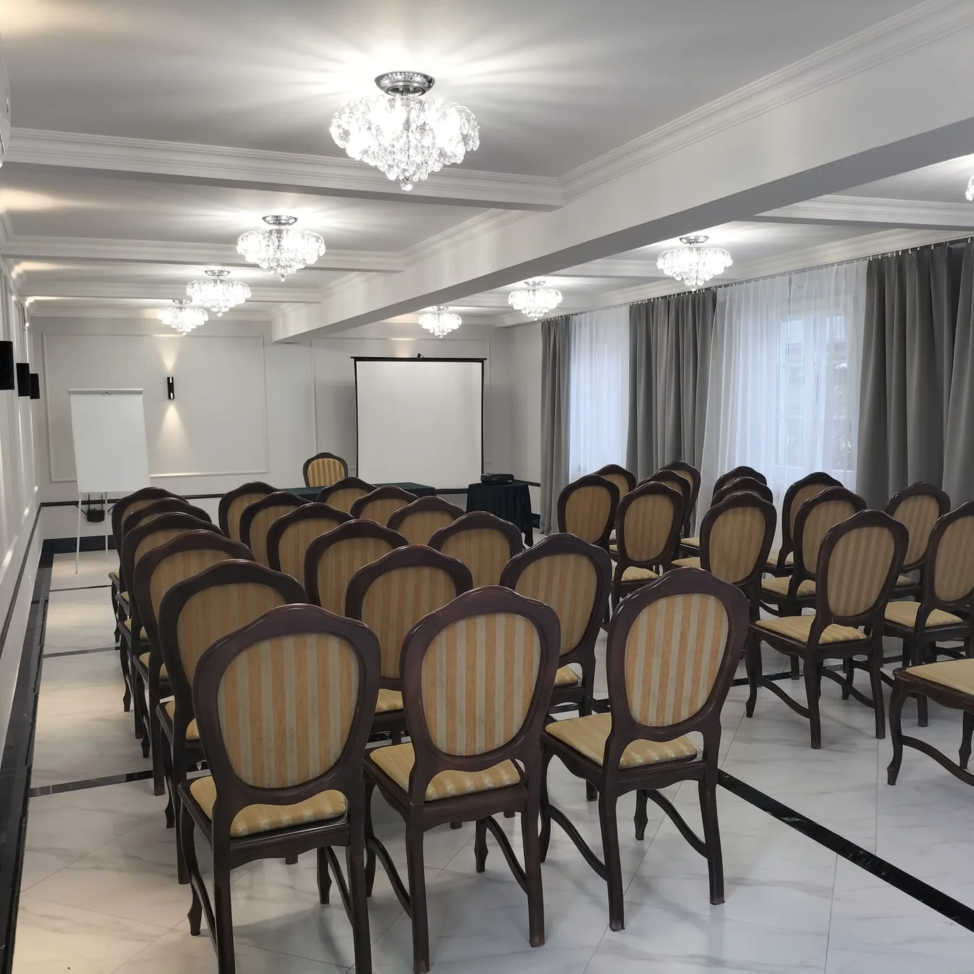 Sala konferencyjna w ustawieniu szkolnym, rzędy krzeseł